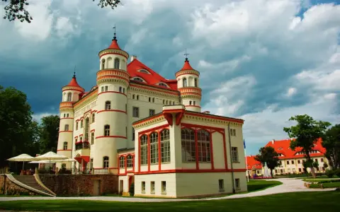 Pałac Wojanów, z jego wieżyczkami i czerwonym dachem, kryje bogatą historię. Otoczony zielenią, zaprasza do odkrywania jego tajemnic.